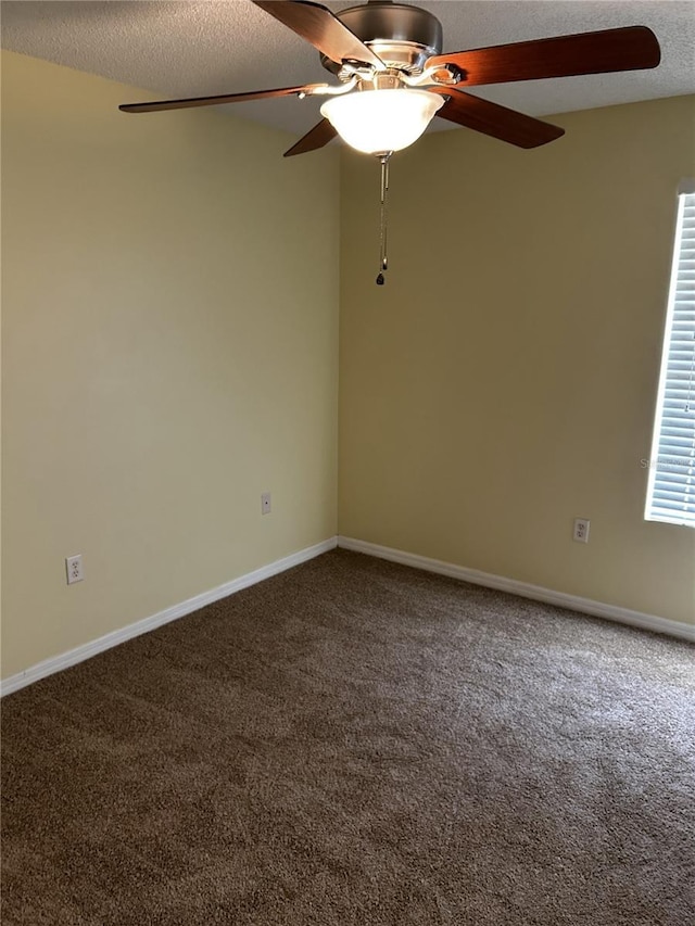 carpeted empty room featuring a textured ceiling