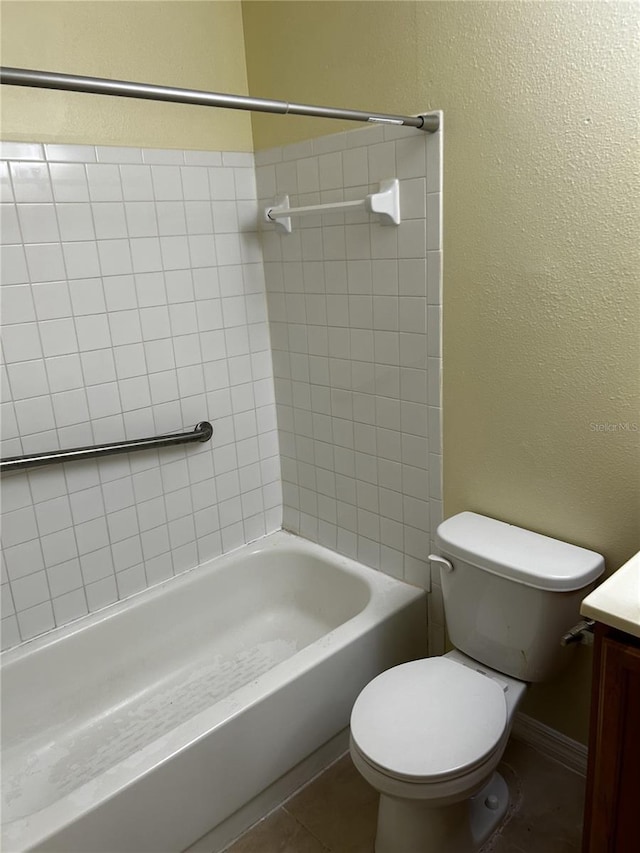 full bathroom featuring tile patterned flooring, vanity, toilet, and tiled shower / bath