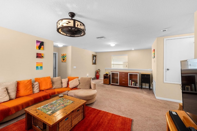 living room featuring carpet flooring and a textured ceiling