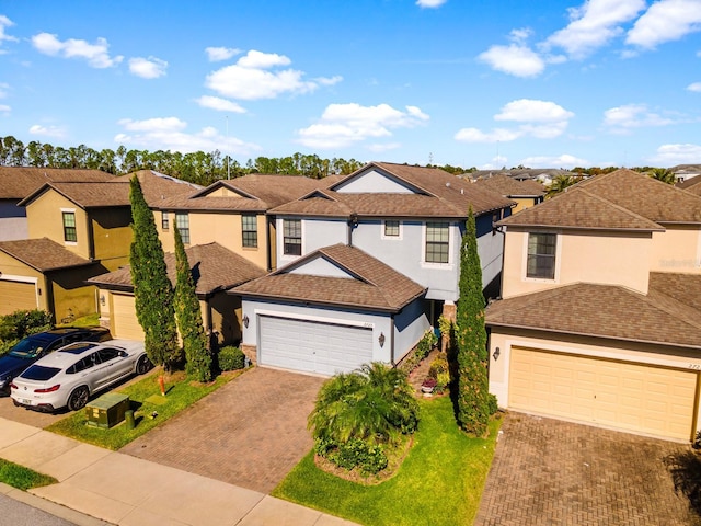 view of front of house with a garage and a front lawn