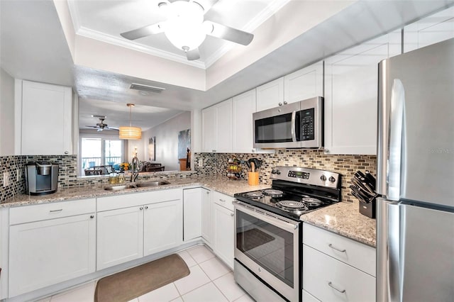 460 Paula Dr S Unit 101, Dunedin, FL 34698 - kitchen with stainless steel appliances, a ceiling fan, a sink, backsplash, and crown molding