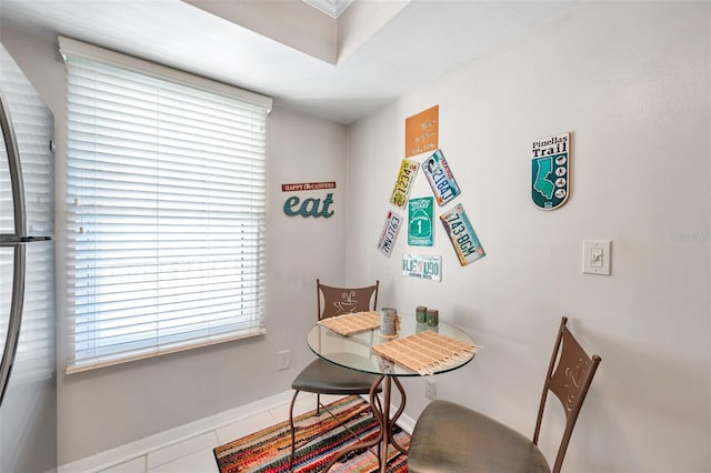 dining room featuring tile patterned floors and a healthy amount of sunlight