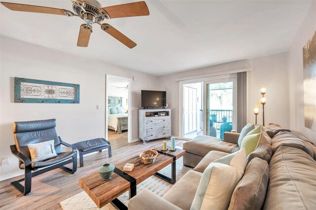 living room featuring light hardwood / wood-style flooring and ceiling fan