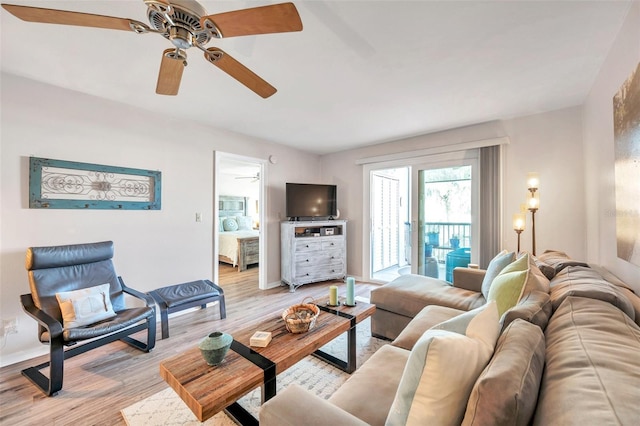 460 Paula Dr S Unit 101, Dunedin, FL 34698 - living area featuring light wood-style floors, a ceiling fan, and baseboards