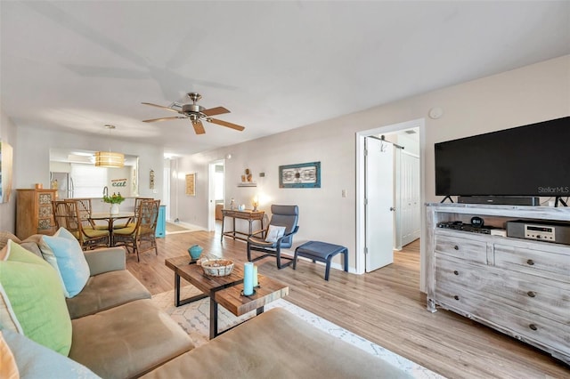 living room featuring ceiling fan and light wood-type flooring