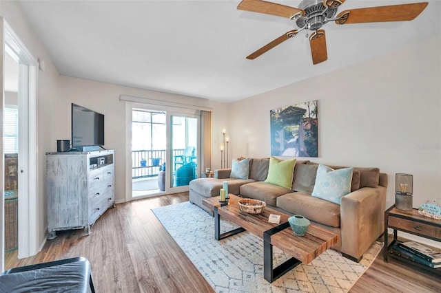 living room featuring ceiling fan and light wood-type flooring