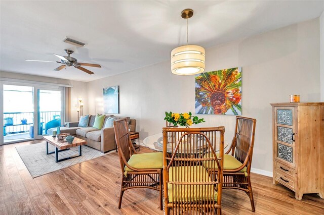 460 Paula Dr S Unit 101, Dunedin, FL 34698 - dining space with light wood-style flooring, a ceiling fan, and baseboards