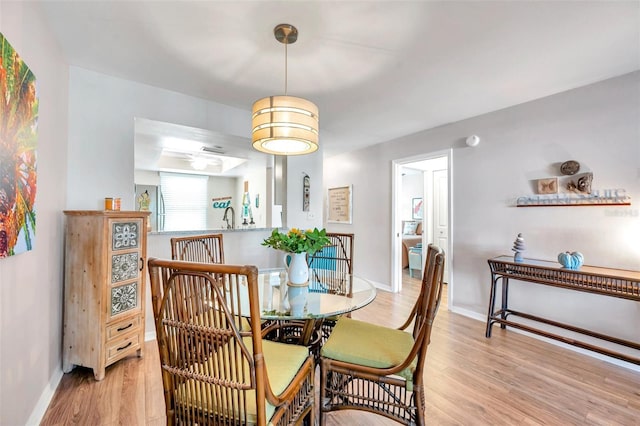 dining space featuring light hardwood / wood-style floors and sink