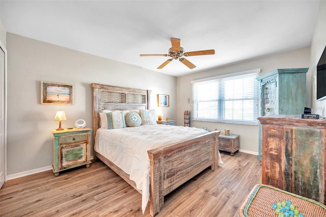 bedroom with light hardwood / wood-style flooring and ceiling fan