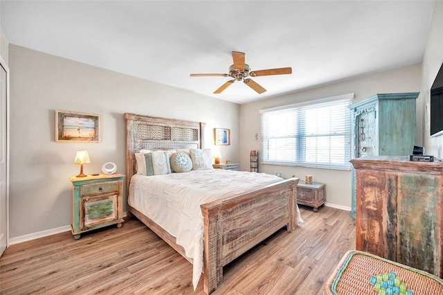 460 Paula Dr S Unit 101, Dunedin, FL 34698 - bedroom with light wood-style flooring, baseboards, and ceiling fan