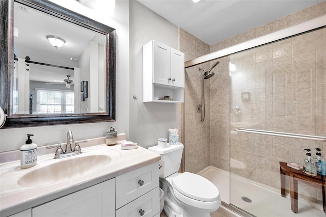460 Paula Dr S Unit 101, Dunedin, FL 34698 - bathroom featuring a shower stall, toilet, vanity, and ceiling fan