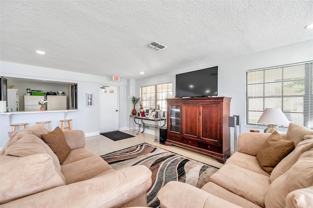 460 Paula Dr S Unit 101, Dunedin, FL 34698 - living area featuring a textured ceiling, recessed lighting, and baseboards