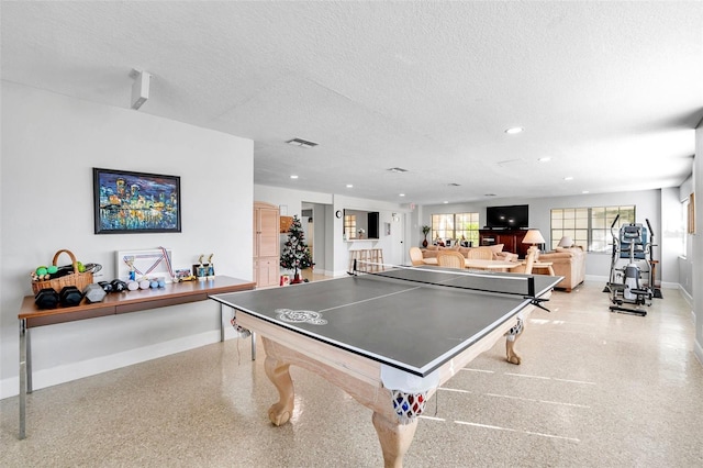 recreation room with a textured ceiling