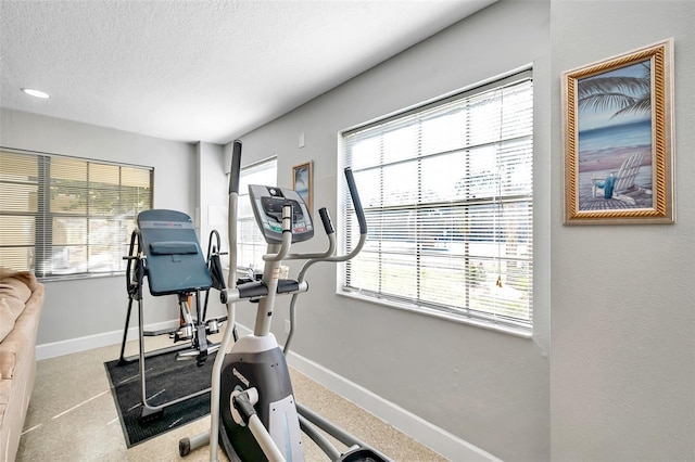 exercise area with a healthy amount of sunlight and a textured ceiling