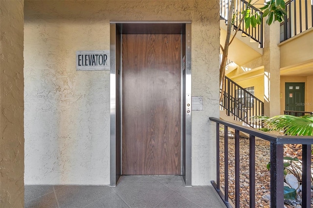 460 Paula Dr S Unit 101, Dunedin, FL 34698 - entrance to property with stucco siding and elevator