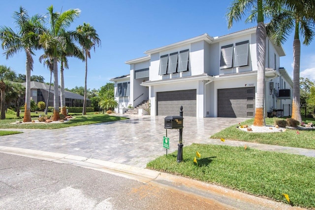 view of front facade featuring a garage and a front lawn