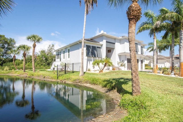 exterior space with a lawn and a water view