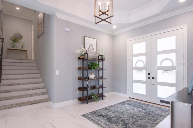 entryway with french doors, ornamental molding, and a notable chandelier