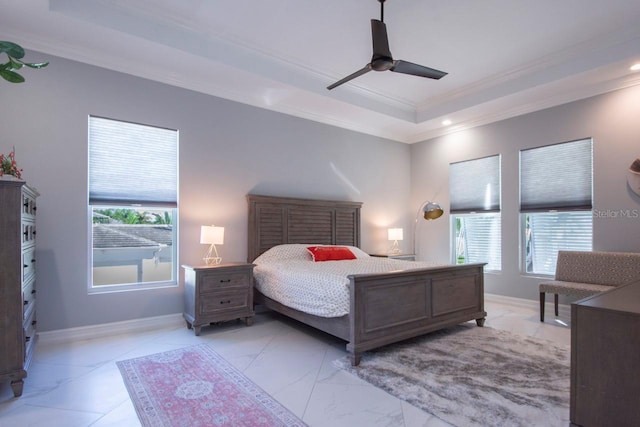 bedroom with multiple windows, a tray ceiling, ceiling fan, and crown molding