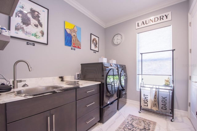 bathroom with crown molding, washing machine and dryer, and sink