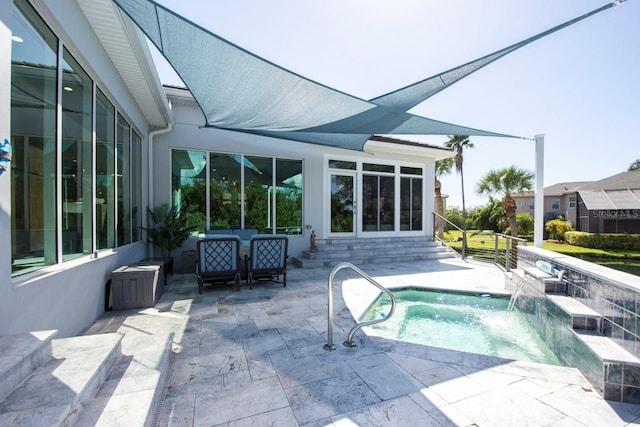 view of swimming pool featuring pool water feature, a patio, and a jacuzzi