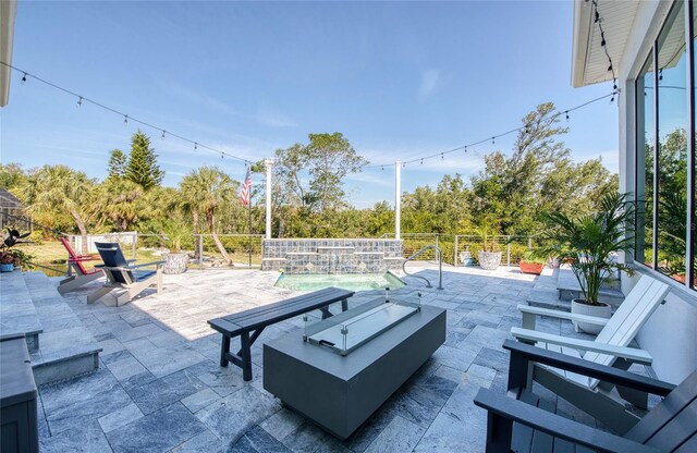 5951 Bay Dr, Gulfport, FL 33707 - view of patio with fence and a fire pit