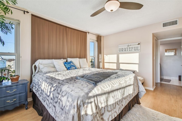 bedroom featuring light hardwood / wood-style floors and ceiling fan