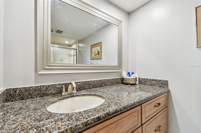 bathroom with vanity and walk in shower