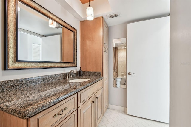 bathroom featuring tile patterned flooring and vanity