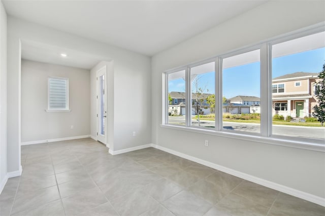 spare room featuring light tile patterned flooring