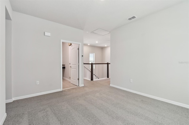 empty room featuring light carpet