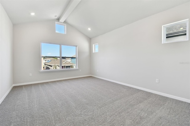 carpeted spare room featuring lofted ceiling with beams