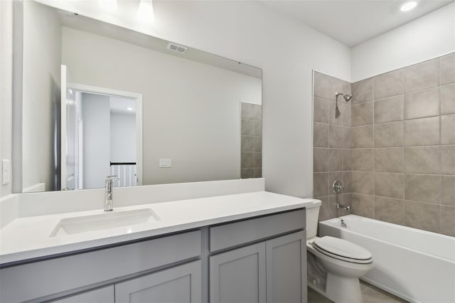 full bathroom featuring vanity, toilet, and tiled shower / bath combo