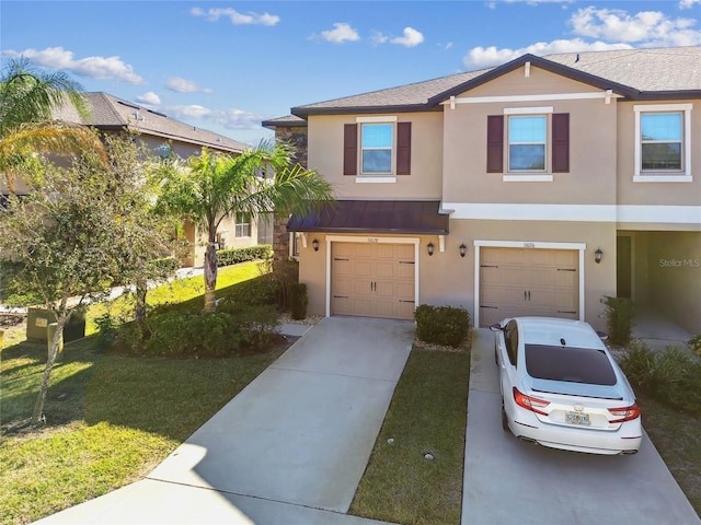 view of front of home with a garage and a front lawn