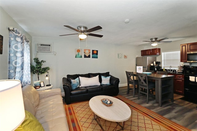 living room with hardwood / wood-style flooring, an AC wall unit, and ceiling fan