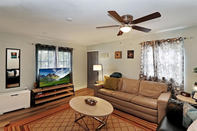 living room featuring hardwood / wood-style floors and ceiling fan