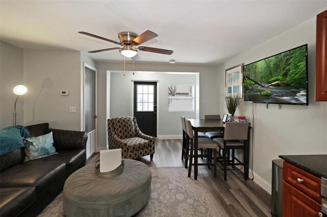 living room featuring hardwood / wood-style floors and ceiling fan