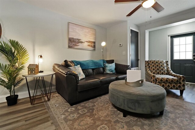 living room featuring dark hardwood / wood-style floors and ceiling fan