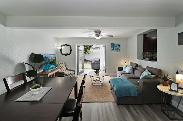 living room featuring ceiling fan and wood-type flooring