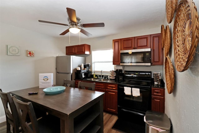 kitchen with ceiling fan, sink, white refrigerator, hardwood / wood-style flooring, and black range with electric stovetop