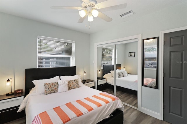 bedroom with dark hardwood / wood-style flooring, a closet, and ceiling fan