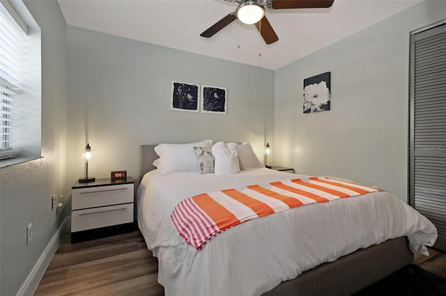 bedroom featuring multiple windows, ceiling fan, and dark hardwood / wood-style flooring