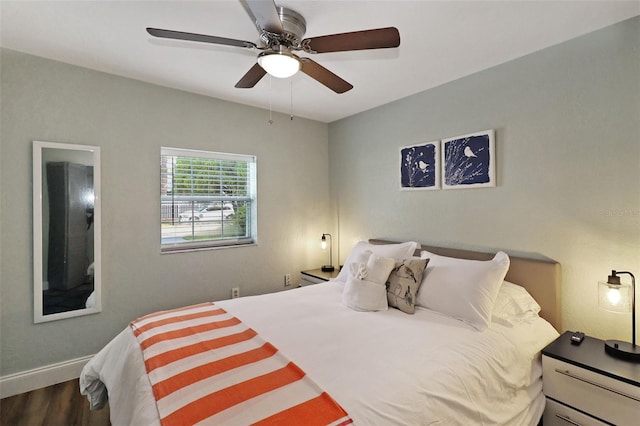 bedroom with ceiling fan and dark wood-type flooring