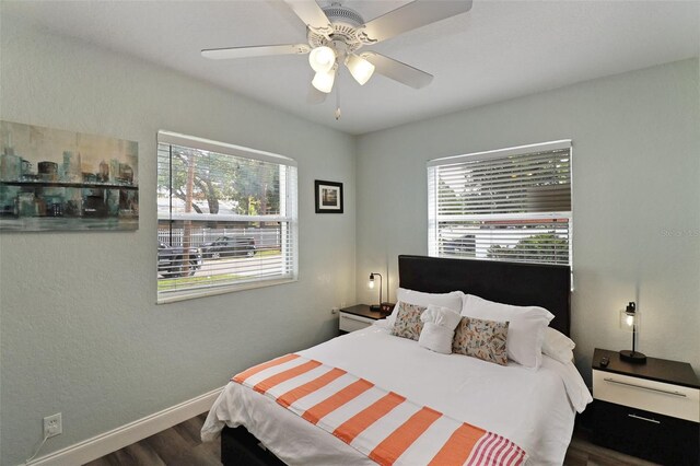 bedroom with ceiling fan and dark wood-type flooring