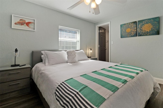 bedroom with ceiling fan and dark hardwood / wood-style flooring