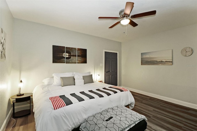 bedroom with ceiling fan and dark wood-type flooring