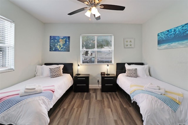 bedroom with ceiling fan and dark wood-type flooring