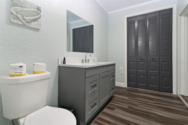 bathroom featuring crown molding, toilet, vanity, and hardwood / wood-style flooring