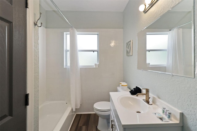 full bathroom featuring hardwood / wood-style flooring, vanity, toilet, and shower / bath combo with shower curtain