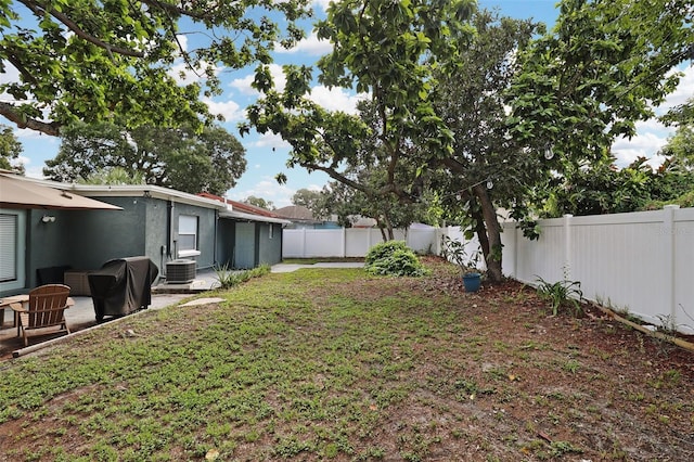 view of yard with a patio and central AC unit